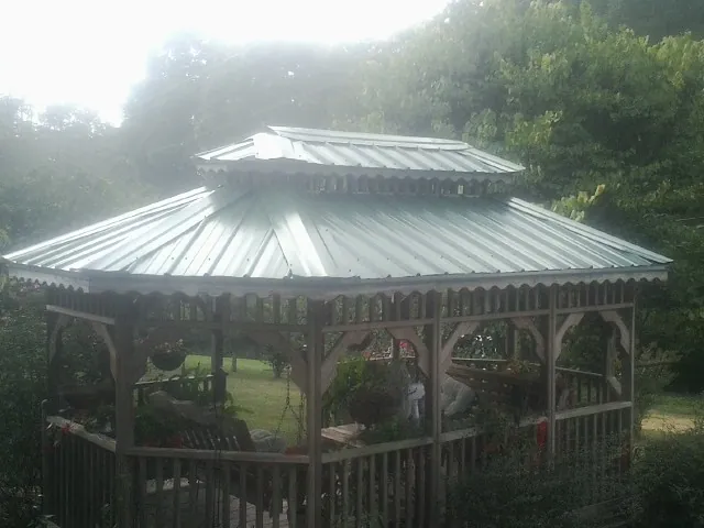Two tier green metal roof on a garden gazebo in Brasstown